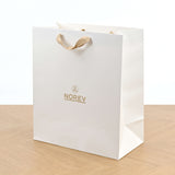 Sac Norev blanc mat et poignées ruban beige